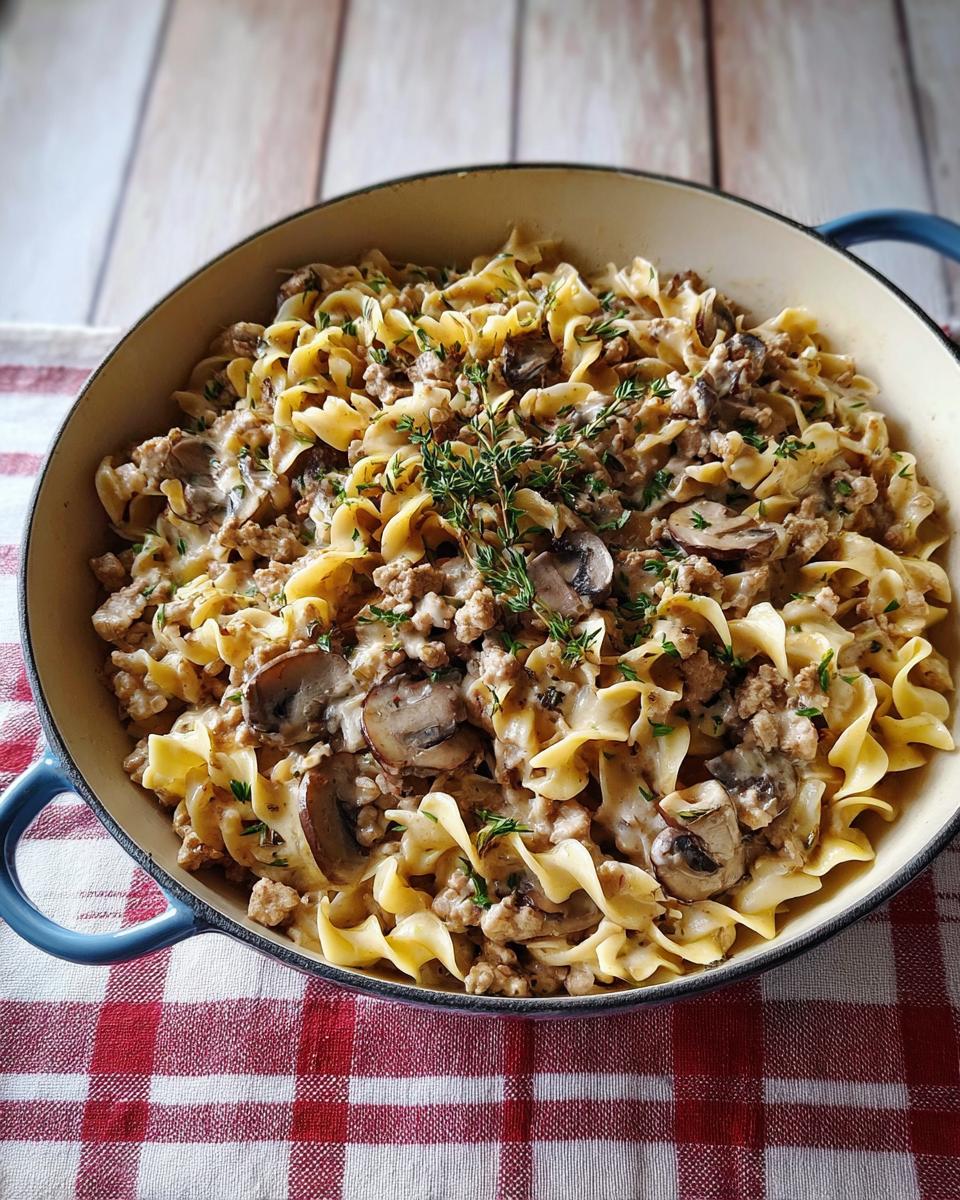A close-up of Creamy Turkey Stroganoff with egg noodles, mushrooms, and ground turkey in a pot.