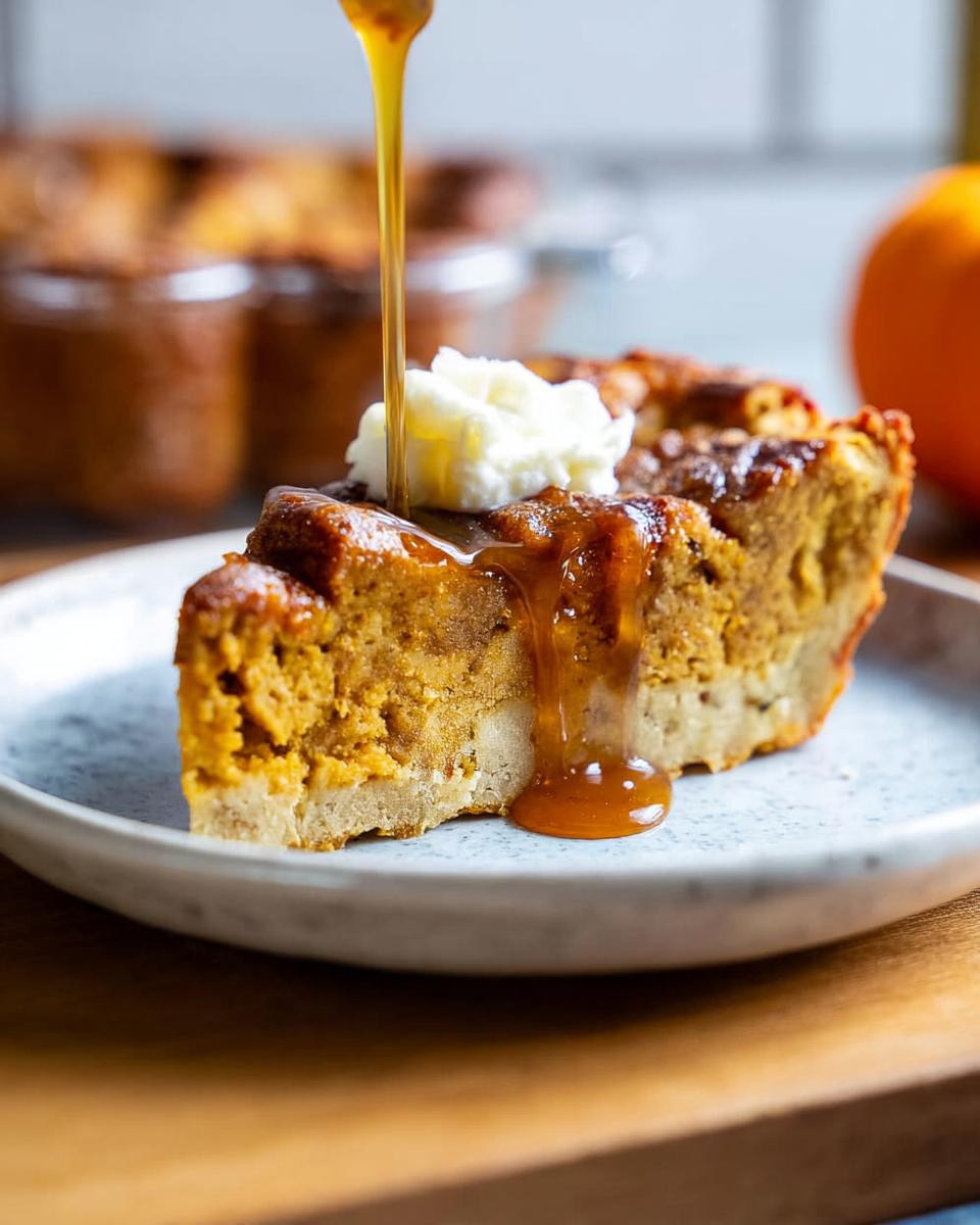 A slice of pumpkin pie, one of the best Thanksgiving desserts, topped with whipped cream and drizzled with caramel sauce.