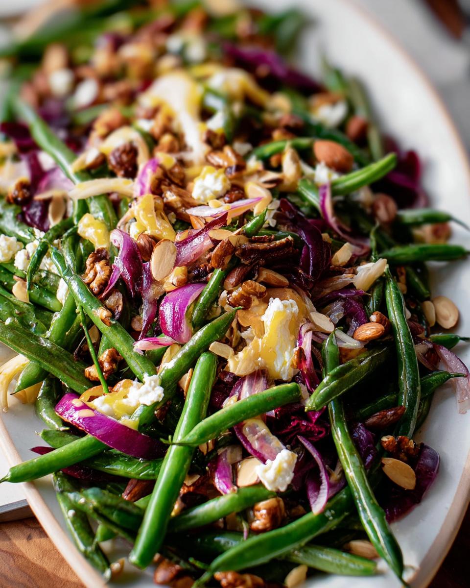 A vibrant Thanksgiving salad featuring crisp green beans, red onion, crumbled feta, and toasted nuts.