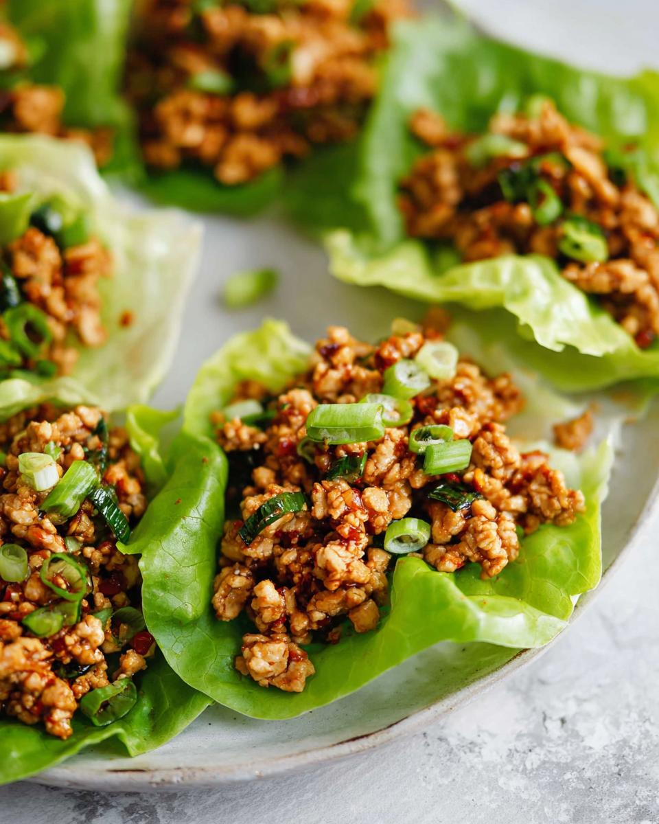Close-up of delicious Turkey Lettuce Wraps (PF-Style) filled with seasoned ground turkey and topped with green onions.