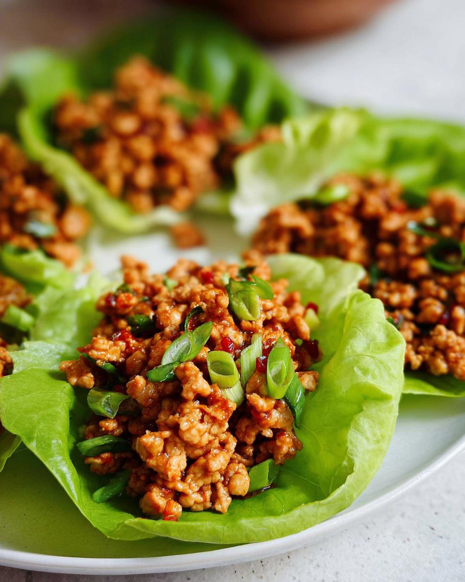 Close-up of delicious Turkey Lettuce Wraps (PF-Style) filled with seasoned ground turkey and topped with green onions.