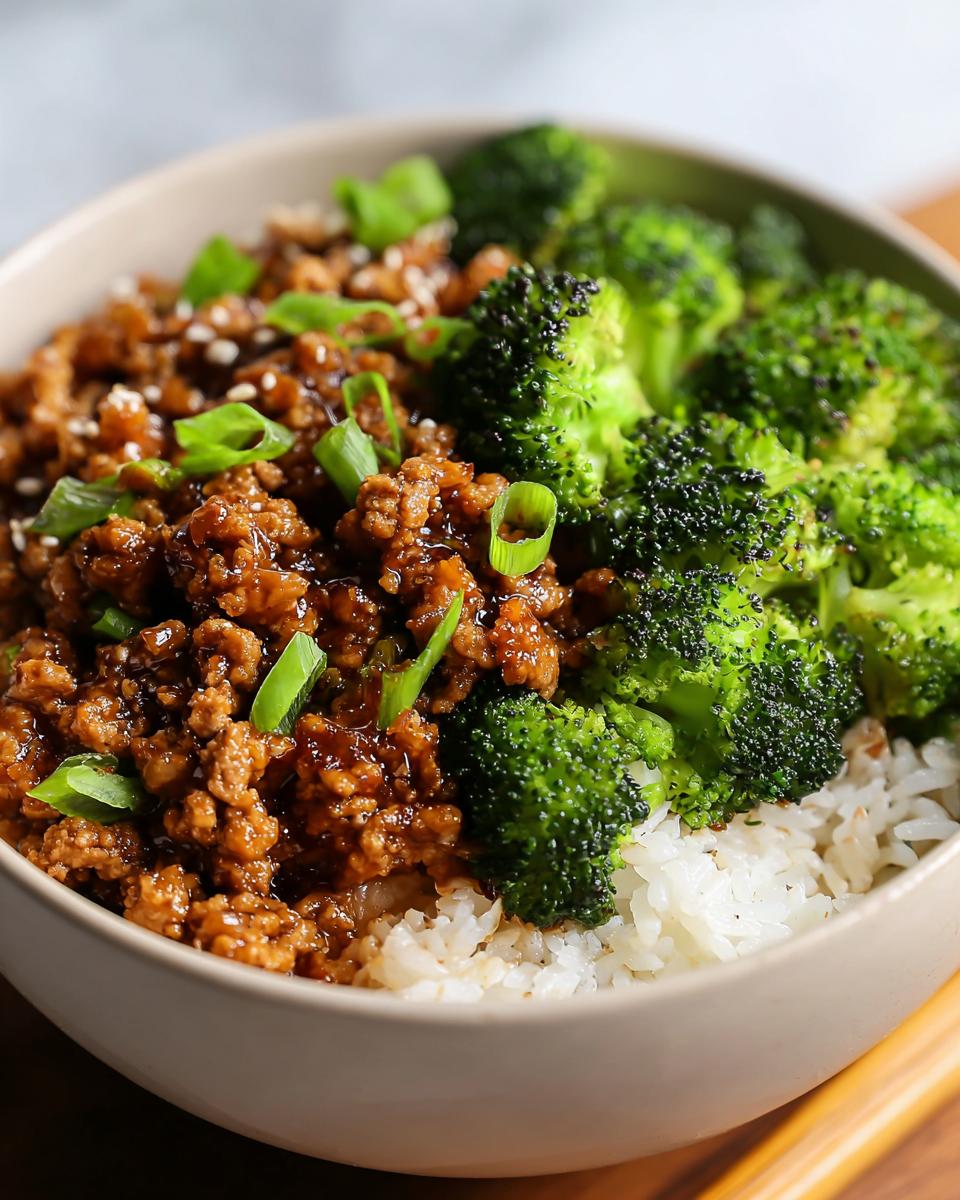 A close-up of a bowl featuring Healthy Honey Garlic Ground Turkey Recipes served over white rice with steamed broccoli.