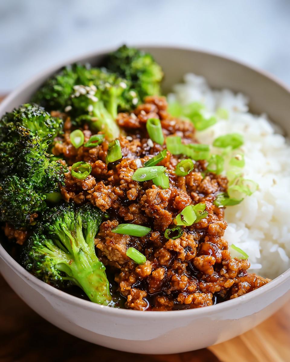 Close-up of a bowl featuring Healthy Honey Garlic Ground Turkey Recipe served over white rice with steamed broccoli.