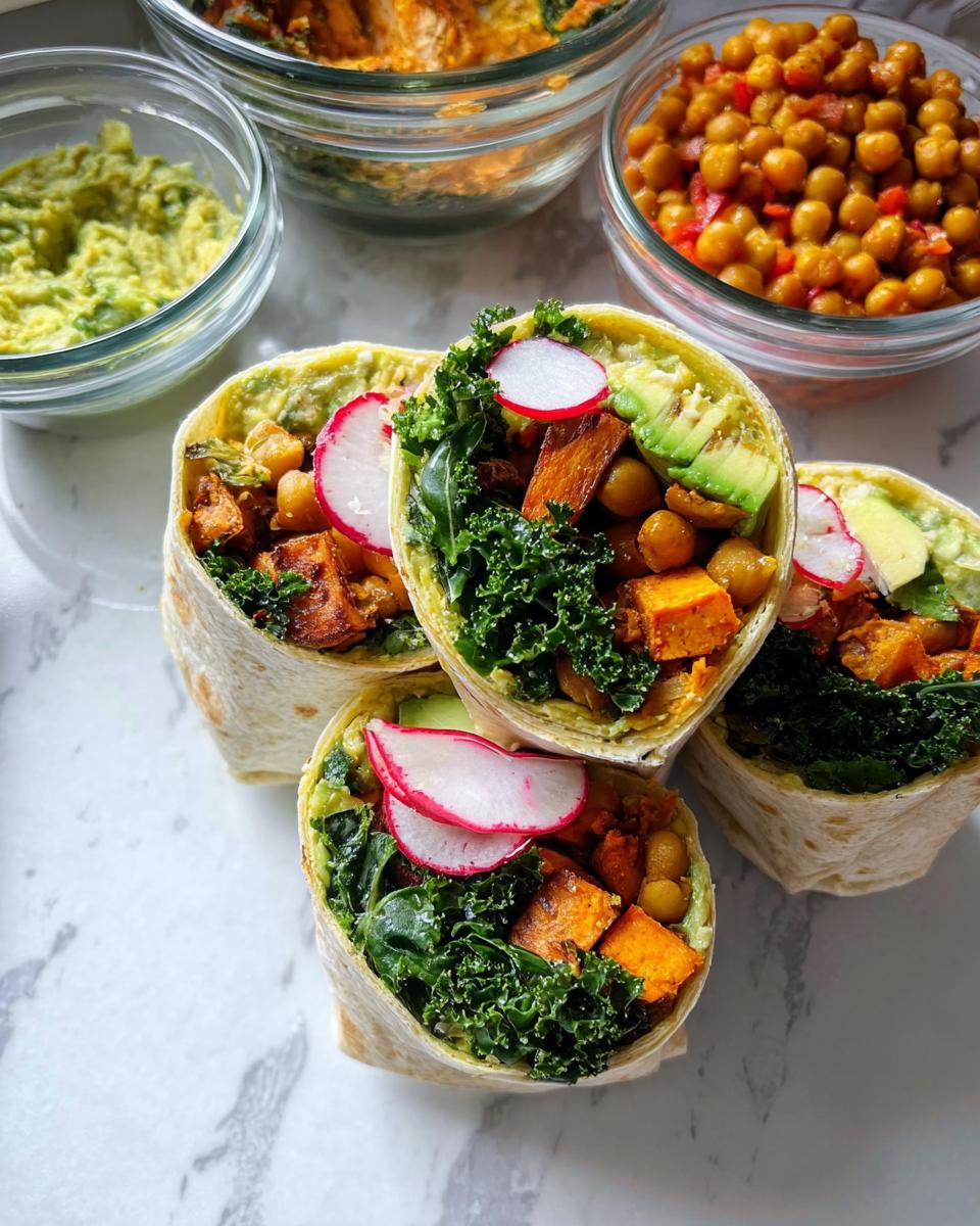 Four meal prep wraps filled with sweet potato, chickpeas, kale, avocado, and radish. Sandwich ideas recipes meal prep.