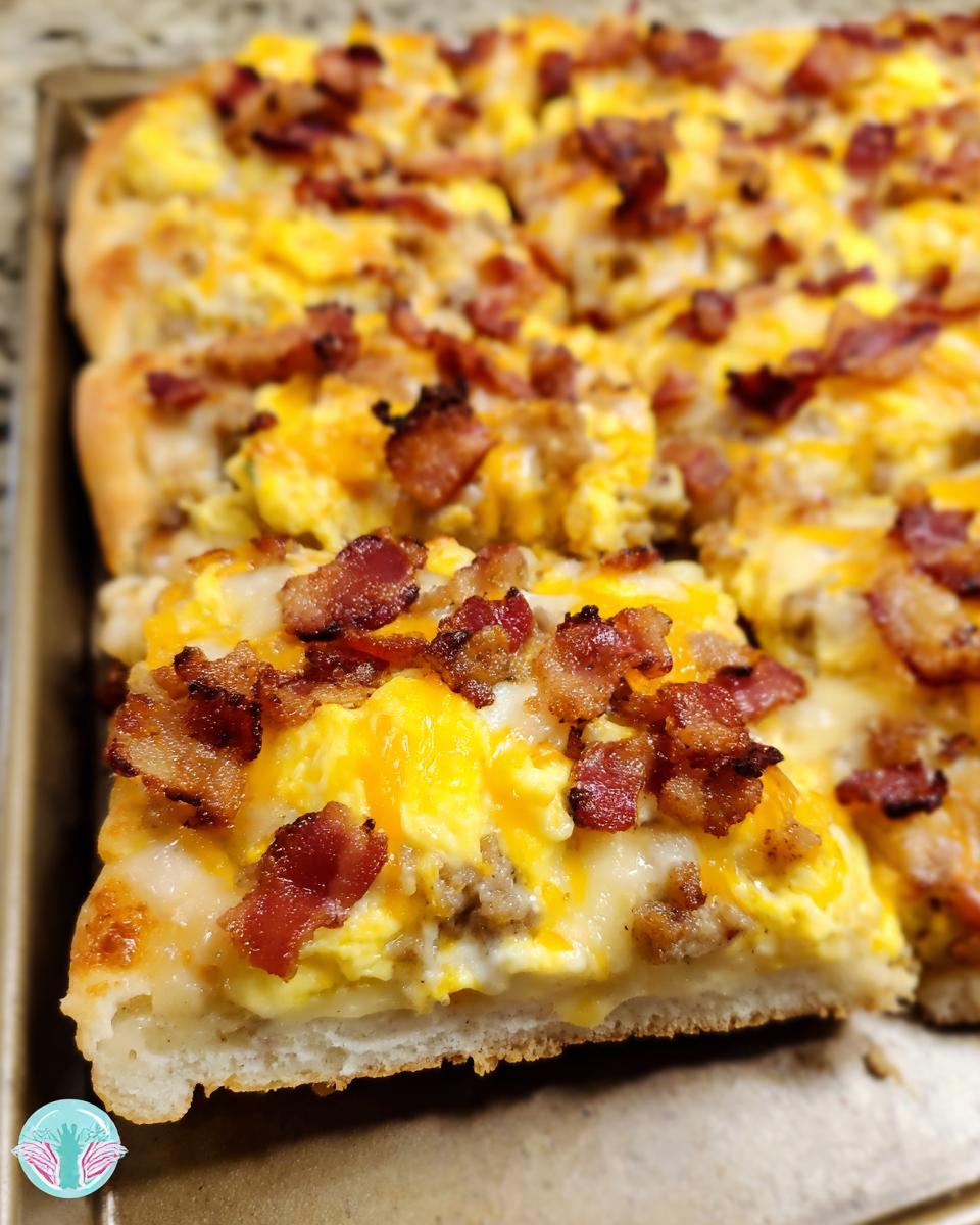 A close-up shot of a slice of breakfast pizza egg recipe, topped with scrambled eggs, cheese, and bacon.