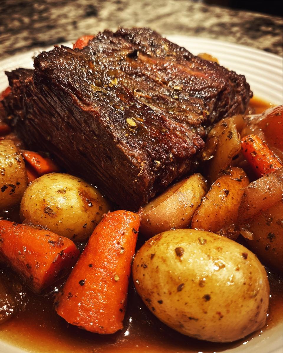 A close-up of a juicy pot roast with tender carrots and potatoes in a rich gravy, perfect for slow cooker recipes.